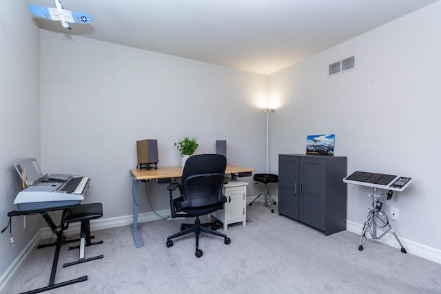 office featuring baseboards, visible vents, and light colored carpet