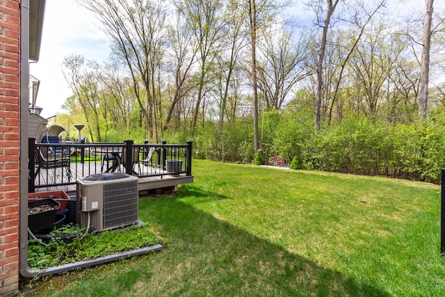 view of yard featuring cooling unit and a deck