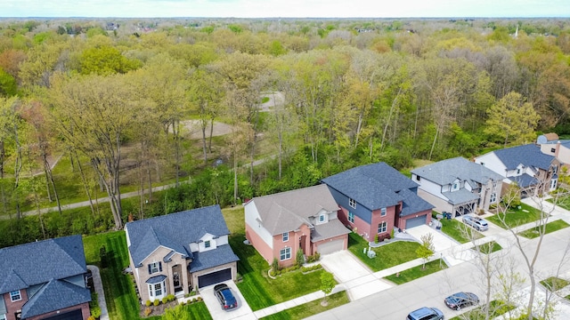 drone / aerial view with a residential view and a view of trees