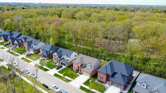 birds eye view of property with a view of trees and a residential view
