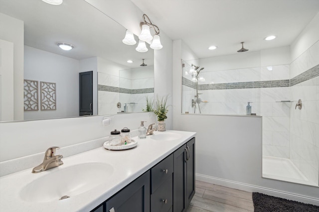 4161 Kim Dr, Hillsdale, MI 49242 - full bathroom featuring walk in shower, double vanity, wood finished floors, and a sink