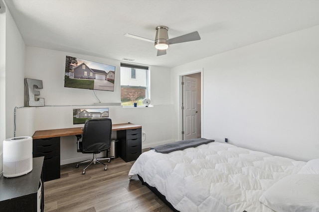 bedroom featuring visible vents, wood finished floors, baseboards, and ceiling fan