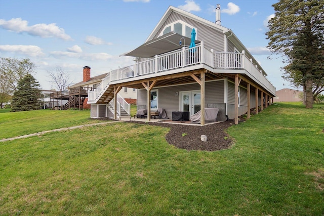back of house with a yard, a deck, a patio area, and stairs