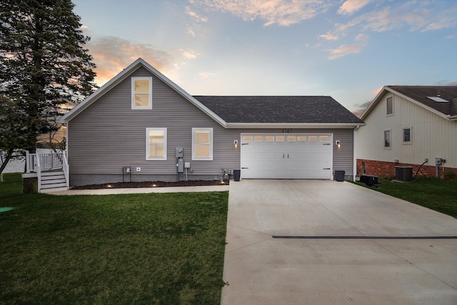 view of front of property with a front lawn, concrete driveway, an attached garage, and cooling unit