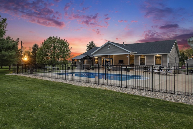 view of swimming pool featuring a yard, fence, a patio, and a fenced in pool