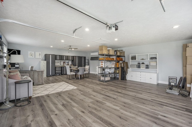 living room with a ceiling fan, baseboards, recessed lighting, and wood finished floors