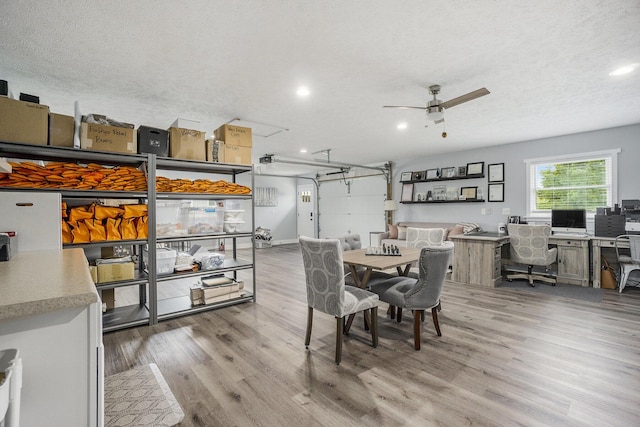 dining room featuring ceiling fan, a textured ceiling, light wood-type flooring, and recessed lighting