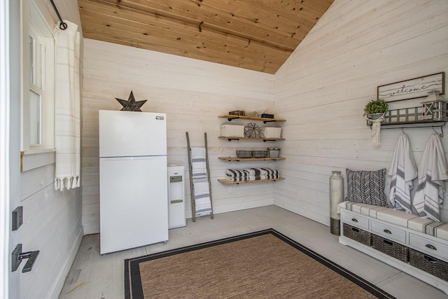 mudroom featuring wooden ceiling, wood walls, and lofted ceiling