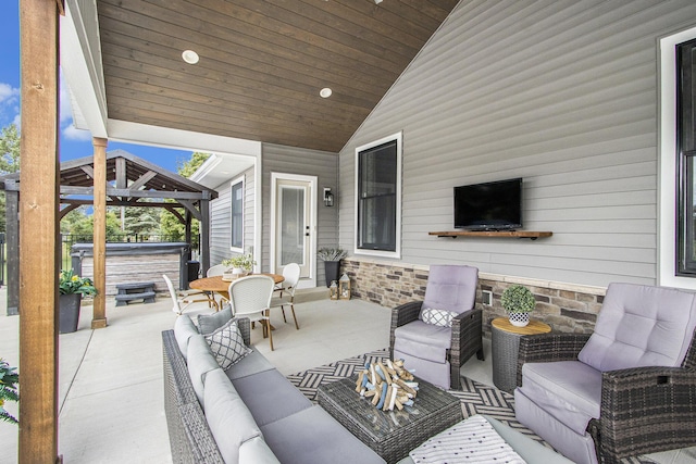 view of patio with an outdoor hangout area, a gazebo, and a hot tub