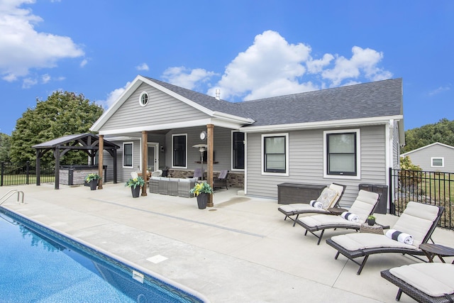 back of property featuring an outdoor hangout area, a gazebo, a patio, and fence