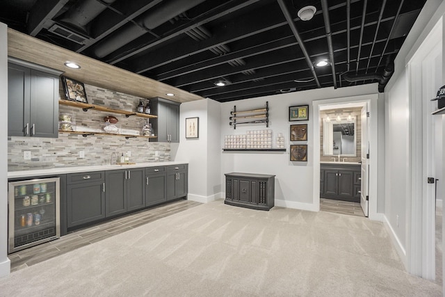 bar featuring baseboards, light colored carpet, wet bar, decorative backsplash, and wine cooler