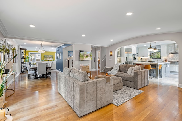 33 Sylvan Ave, Pleasant Ridge, MI 48069 - living room featuring ornamental molding, plenty of natural light, ornate columns, and arched walkways