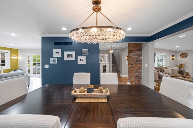 33 Sylvan Ave, Pleasant Ridge, MI 48069 - dining room with wood finished floors, visible vents, crown molding, an inviting chandelier, and a wealth of natural light