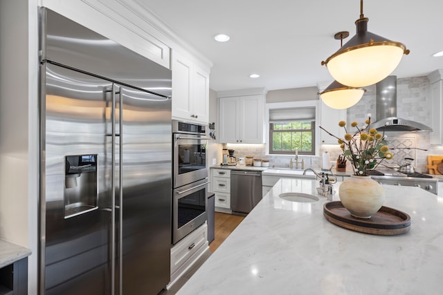 33 Sylvan Ave, Pleasant Ridge, MI 48069 - kitchen with a sink, white cabinetry, wall chimney exhaust hood, stainless steel appliances, and tasteful backsplash