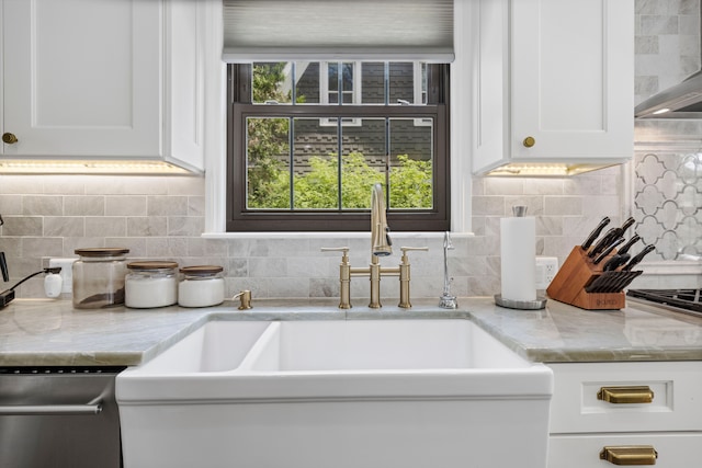 33 Sylvan Ave, Pleasant Ridge, MI 48069 - room details with stainless steel dishwasher, a sink, white cabinetry, decorative backsplash, and wall chimney exhaust hood