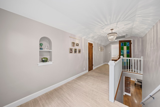 33 Sylvan Ave, Pleasant Ridge, MI 48069 - corridor with an upstairs landing, built in features, vaulted ceiling, a chandelier, and baseboards