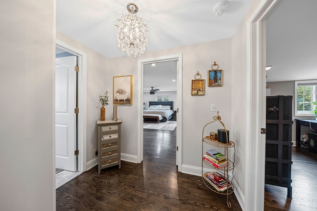 33 Sylvan Ave, Pleasant Ridge, MI 48069 - corridor with wood finished floors, baseboards, and a notable chandelier