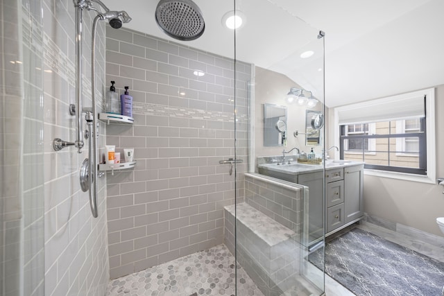 33 Sylvan Ave, Pleasant Ridge, MI 48069 - full bath with double vanity, vaulted ceiling, a tile shower, and a sink