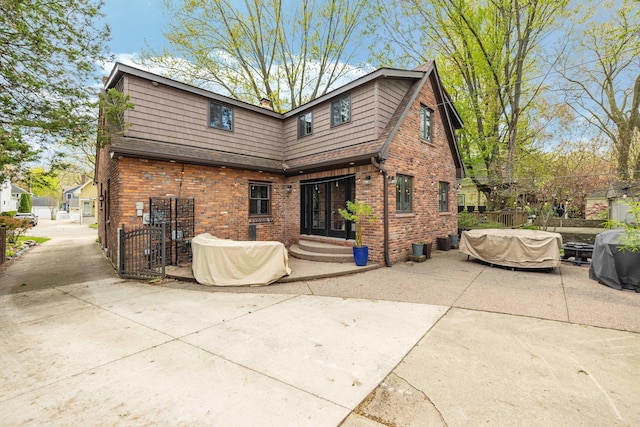 33 Sylvan Ave, Pleasant Ridge, MI 48069 - back of property featuring a patio area, fence, a shingled roof, and brick siding