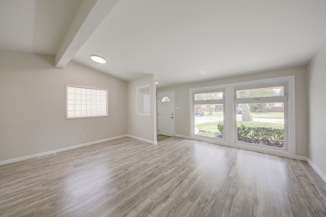 unfurnished living room featuring light wood finished floors and baseboards