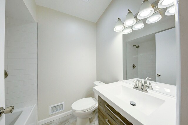 bathroom featuring toilet, vanity, baseboards, and  shower combination