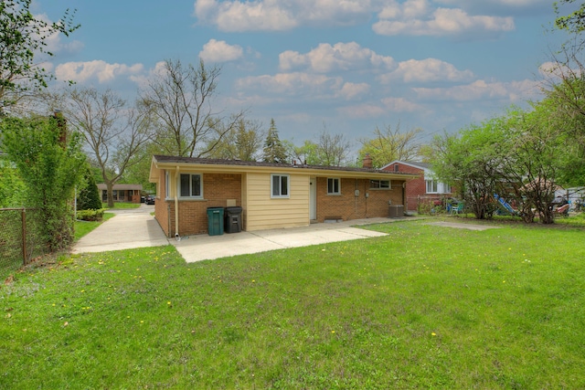 back of house featuring a patio area, brick siding, a chimney, and central AC unit