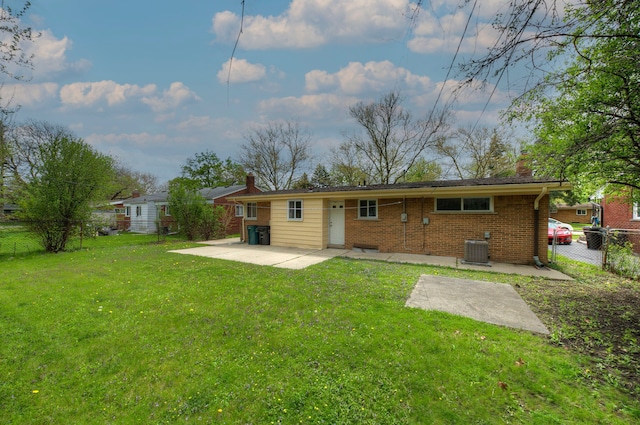 rear view of property with cooling unit, a patio, a chimney, and brick siding