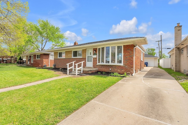 ranch-style home featuring brick siding, a chimney, a front yard, and a detached garage
