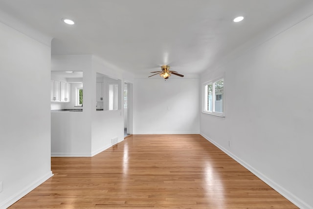 unfurnished living room featuring ceiling fan, baseboards, light wood finished floors, and recessed lighting