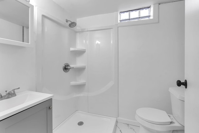 bathroom featuring walk in shower, toilet, marble finish floor, and vanity