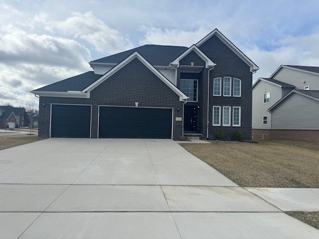view of front of house with a front yard, an attached garage, brick siding, and driveway
