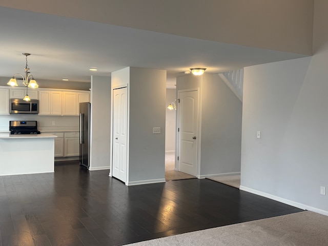 unfurnished living room featuring dark wood finished floors, baseboards, and recessed lighting