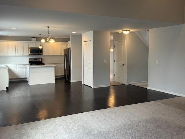 kitchen featuring appliances with stainless steel finishes, a kitchen island, baseboards, and recessed lighting