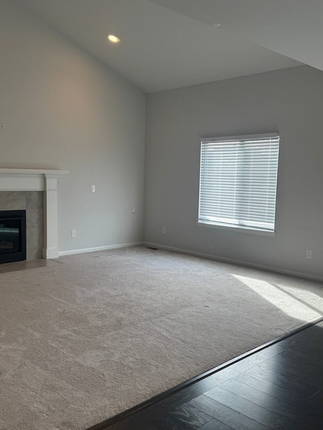 unfurnished living room with a fireplace, baseboards, and recessed lighting