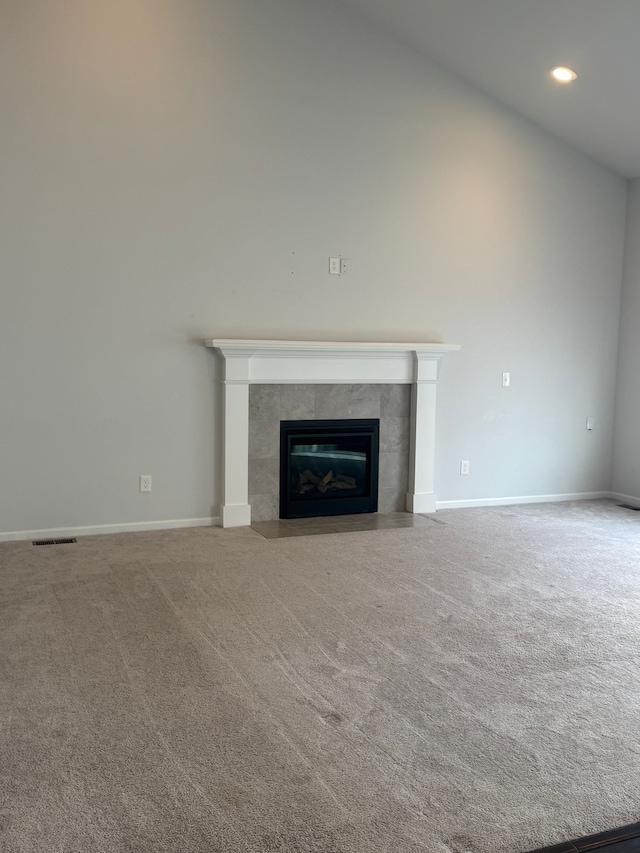 unfurnished living room featuring a fireplace, carpet, baseboards, and recessed lighting