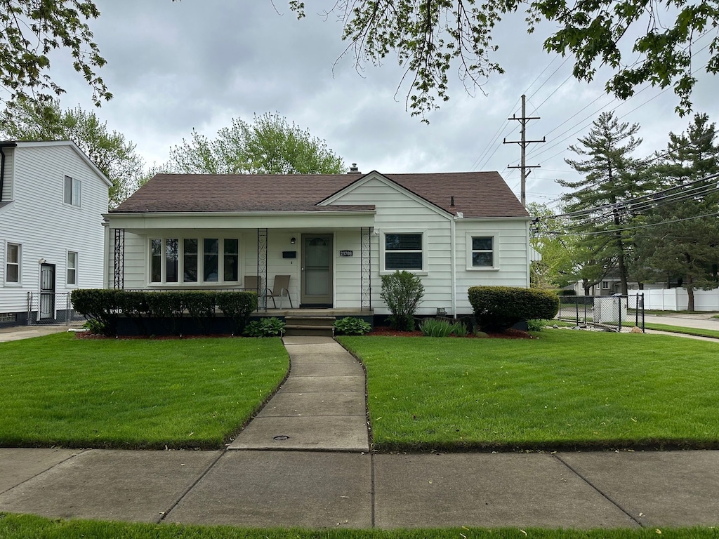view of front of property with a porch and roof with shingles
