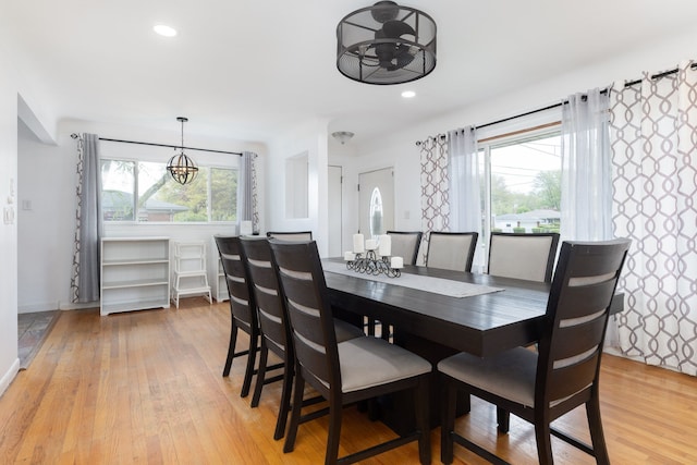dining space featuring a chandelier, light wood-style floors, recessed lighting, and baseboards
