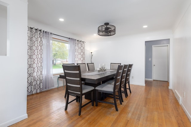 dining room with light wood-style floors, baseboards, and recessed lighting