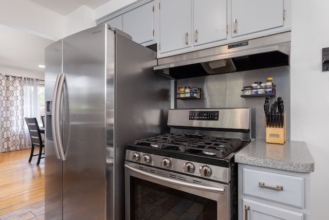 kitchen featuring stainless steel appliances, under cabinet range hood, light wood-type flooring, and open shelves