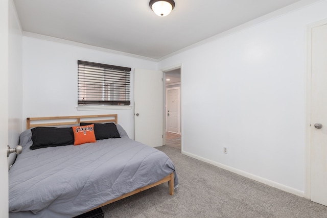 bedroom featuring carpet flooring, ornamental molding, and baseboards