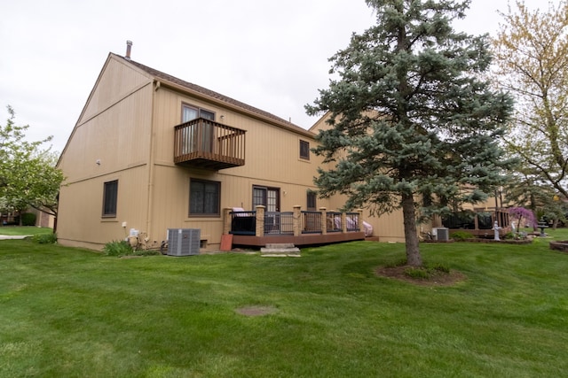 back of house featuring a lawn, a deck, cooling unit, and a balcony