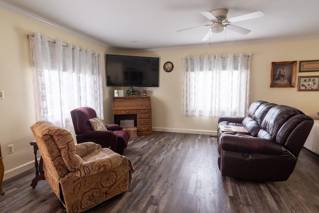 living area featuring dark wood finished floors, a ceiling fan, and a healthy amount of sunlight