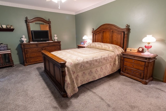 bedroom with ornamental molding, carpet flooring, and ceiling fan