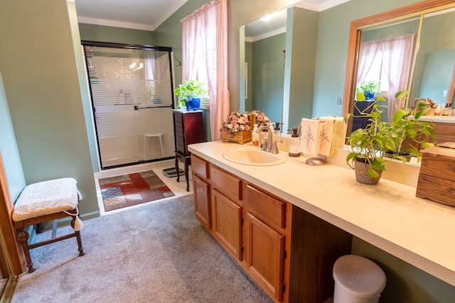 full bath featuring vanity, a stall shower, ornamental molding, and carpet floors