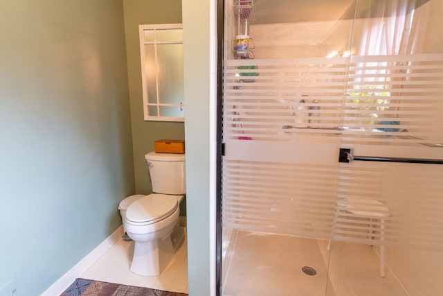 full bath with toilet, baseboards, a shower stall, and tile patterned floors
