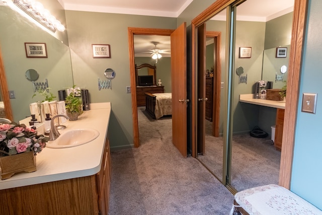 bathroom featuring vanity, ensuite bathroom, and baseboards