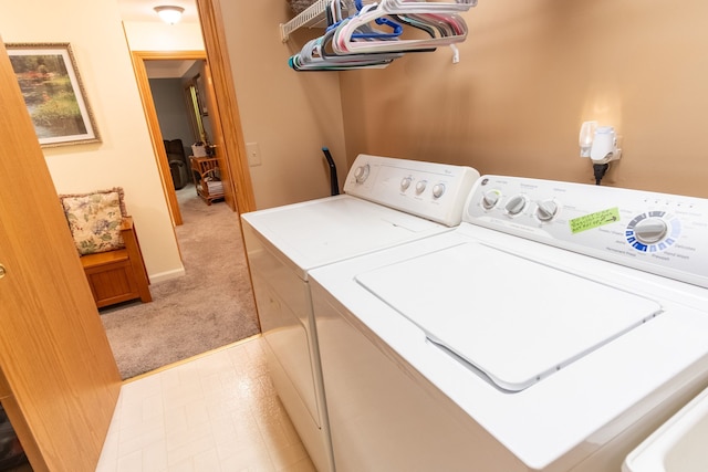 washroom featuring washer and dryer and light colored carpet