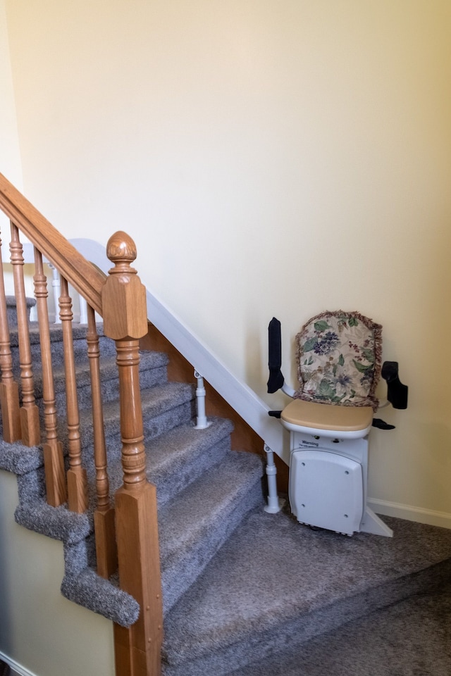 stairs with baseboards and carpet flooring