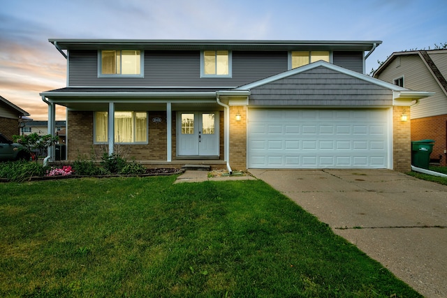 traditional-style house featuring an attached garage, brick siding, and driveway