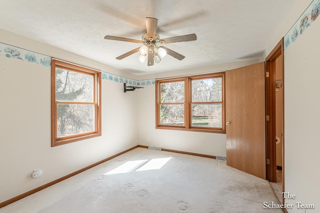 unfurnished bedroom featuring carpet flooring, visible vents, and a textured ceiling